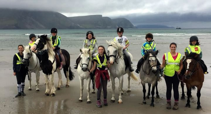 Children at pony camp on horses at Keel beach